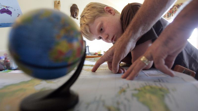 Sevenyearold Logan Gould learning about the different countries that will compete in the olympics during a homeschool session with his parents Loren and Ron Gould August 8, 2008.