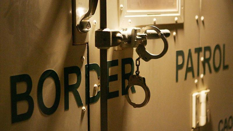 Handcuffs secure door of CBP vehicle in 2006