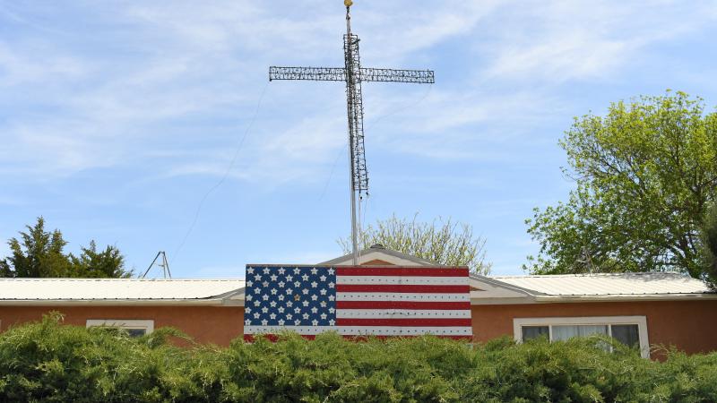 A cross and American flag are up outside a home on May 14, 2020 in Eads, Colorado.