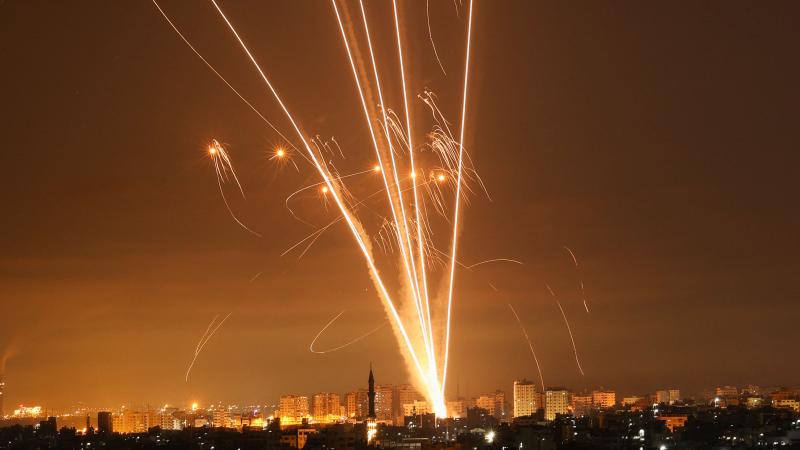 Rockets light up the night sky as they are fired towards Israel from Beit Lahia in the northern Gaza Strip on May 14, 2021.
