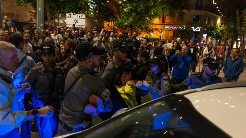 Police arrest a protester at a demonstration organized by the Standing Together Movement, which calls Arabs and Jews to unite, and demands the end of attacks on both Israel and Gaza, on May 15, 2021, in Jerusalem, Israel.