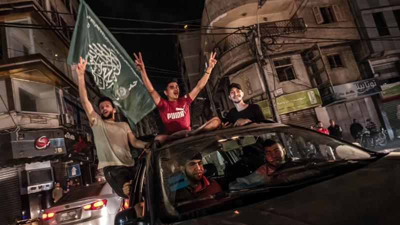 Palestinians celebrate the cease-fire agreement between Israel and Hamas on May 21, 2021 in Gaza City, Gaza.