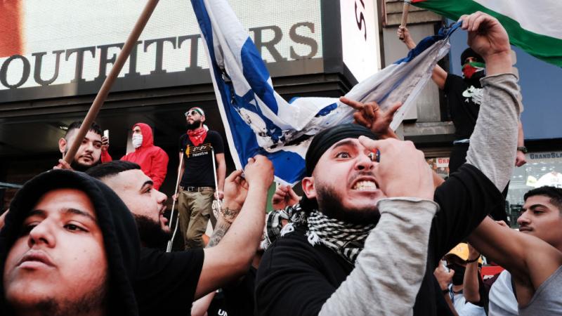 Pro-Palestinian protestors face off against Israel supporters and police in Times Square on May 20, 2021