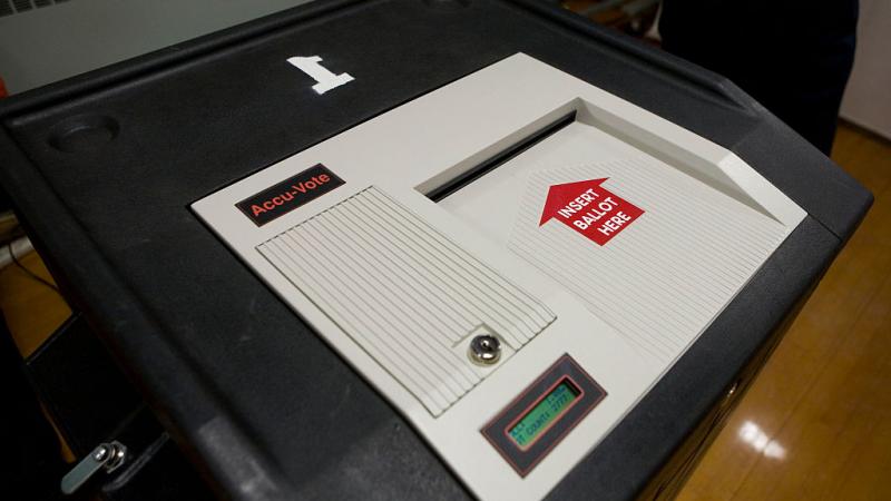 An AccuVote electronic scanning machine is used for counting the votes in New Hampshire