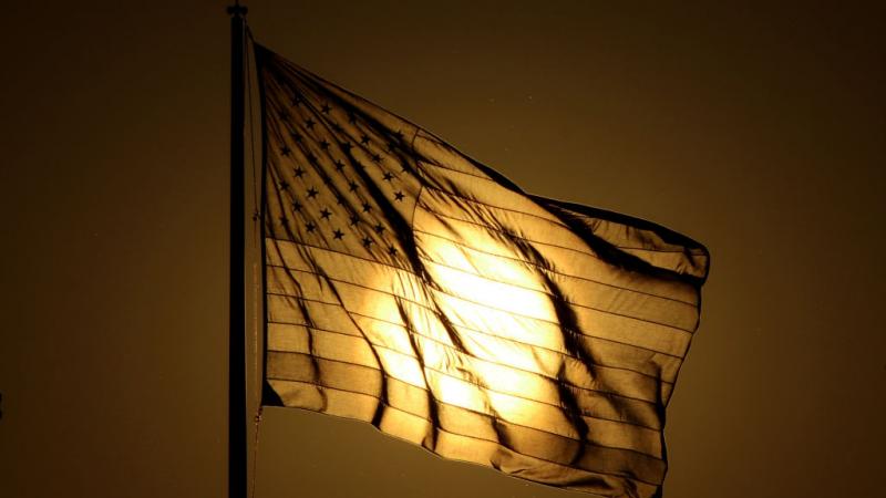 Sun sets behind American flag in New Jersey in 2017