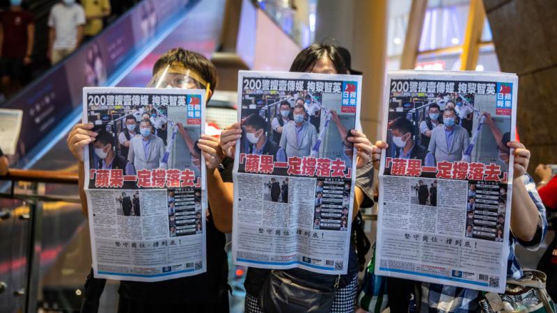 Protesters with newspaper Apple Daily, Hong Kong.