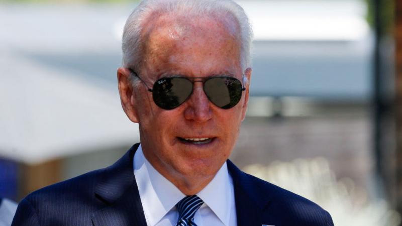 President Joe Biden wearing sun glasses.