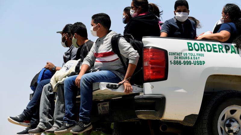 Migrants attempting to cross in to the U.S. from Mexico are detained by U.S. Customs and Border Protection at the border May 21, 2021 in San Luis, Arizona.