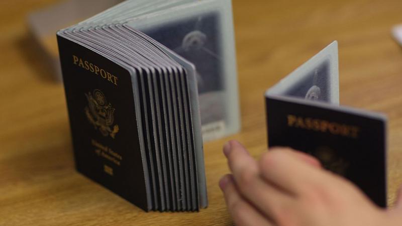 Passport processing employee uses stack of blank passports to print new one in Florida in 2007