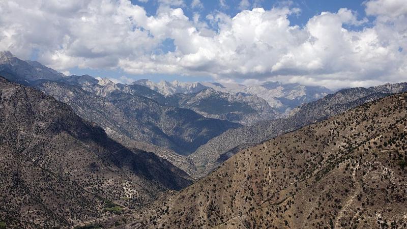 US Army soldiers fly though mountainous terrain in Afghanistan in 2009