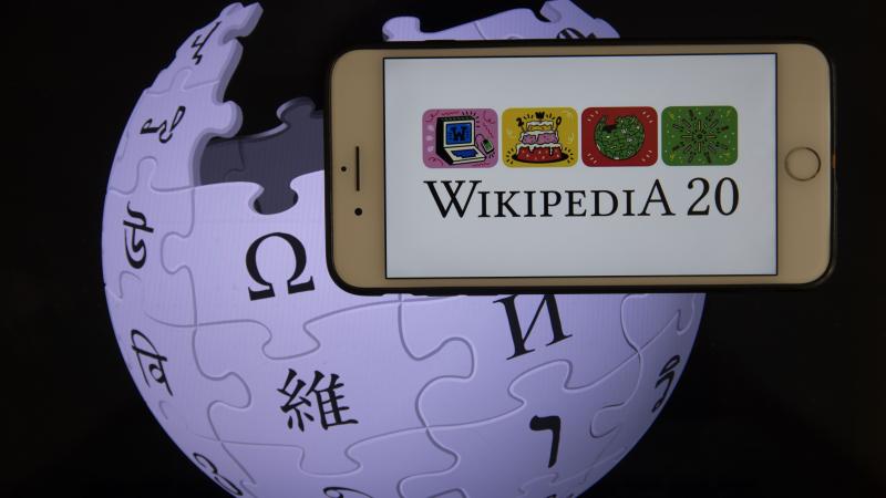 In this illustration photo Wikipedia logos are displayed on a smartphone and a screen in Ankara, Turkey on January 19, 2021.