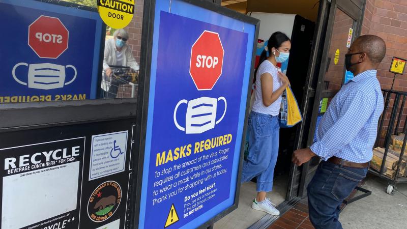 People shop at a grocery store enforcing the wearing of masks in Los Angeles on July 23, 2021.