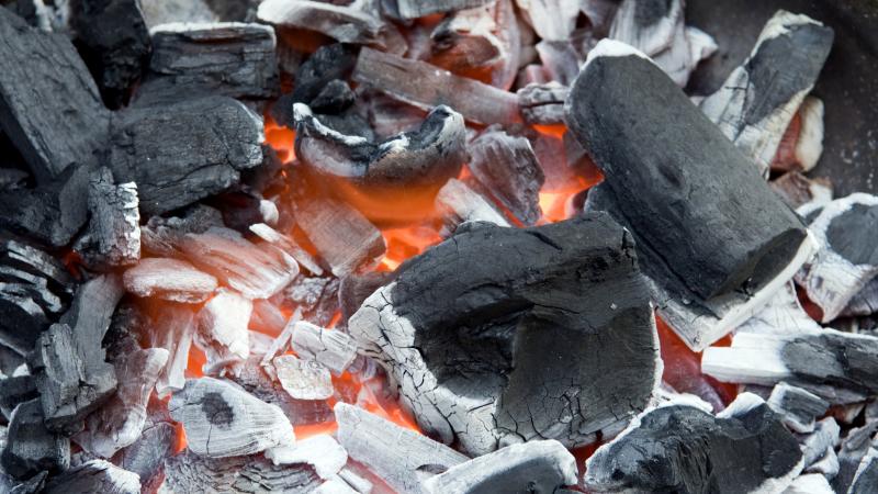 Lump charcoal in a grill.