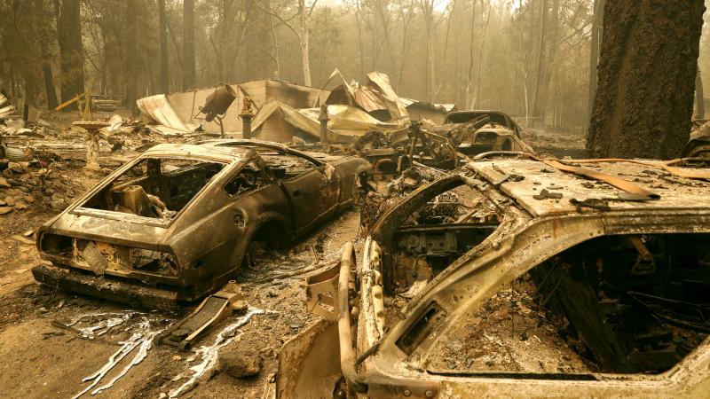 Burned out cars sit in front of a home that was destroyed by the Dixie Fire on July 26, 2021 in Indian Falls, California.