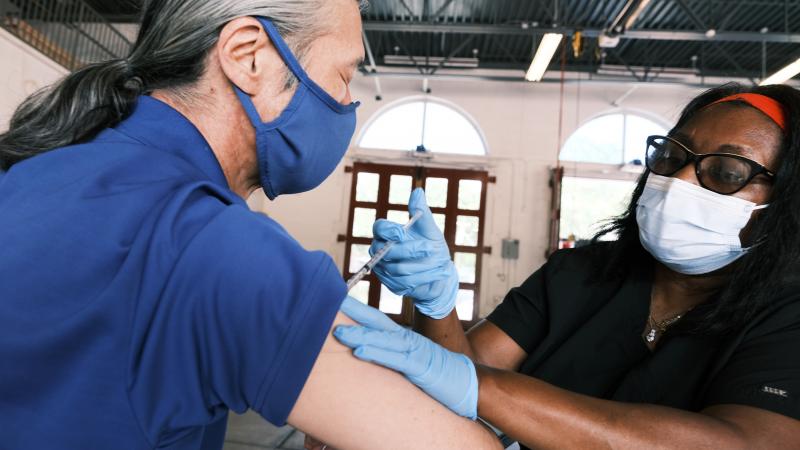 Soby Bai gets a COVID vaccine at a clinic on August 04, 2021 in Ferguson, Missouri.