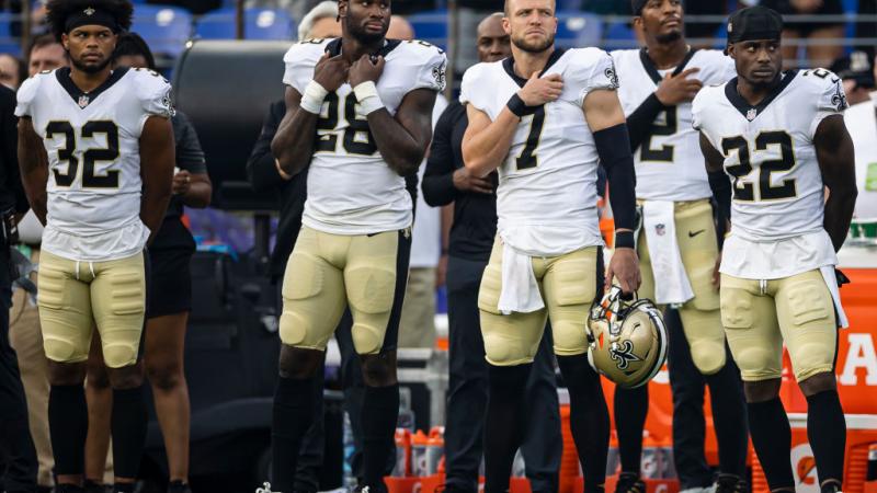 New Orleans Saints stand for the National Anthem before a preseason game