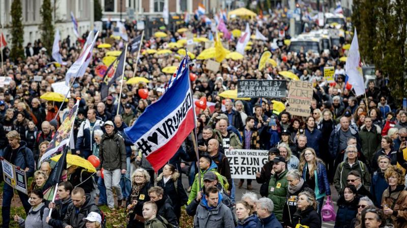 Opponents of the coronavirus measures take part in a protest march during the "Together for the Netherlands" manifestation in the Hague, on November 7, 2021