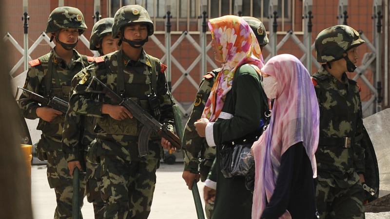 Uyghur Women, Chinese paramilitary police, Xinjiang, China, July 3, 2010