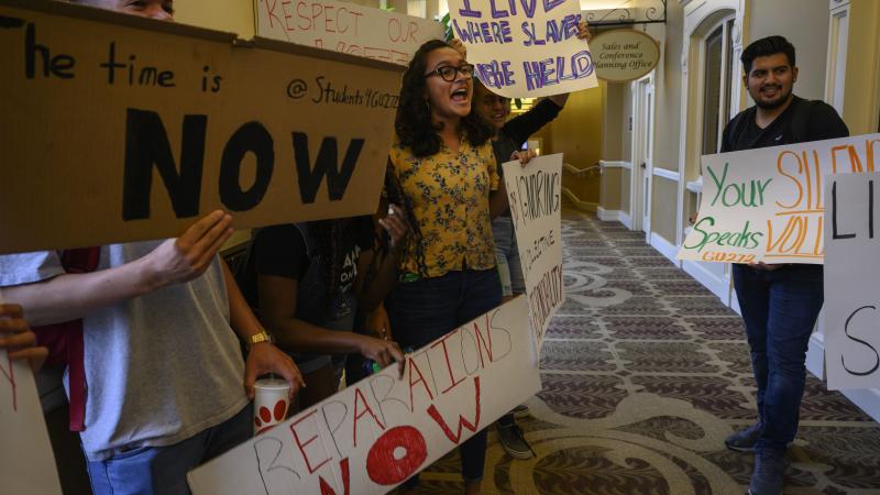 Students at Georgetown University protested for the school to make amends for its history, with reparations funded by student fees to be directed to charities benefiting descendants of enslaved people, outside a Board of Directors meeting held on campus in Washington DC on October 3, 2019.