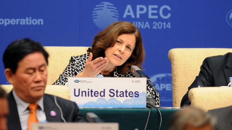 US Deputy Secretary Sarah Bloom Raskin (C) answers a question at a press conference during the Asia-Pacific Economic Cooperation (APEC) Finance Ministers's Meeting in Beijing on October 22, 2014.