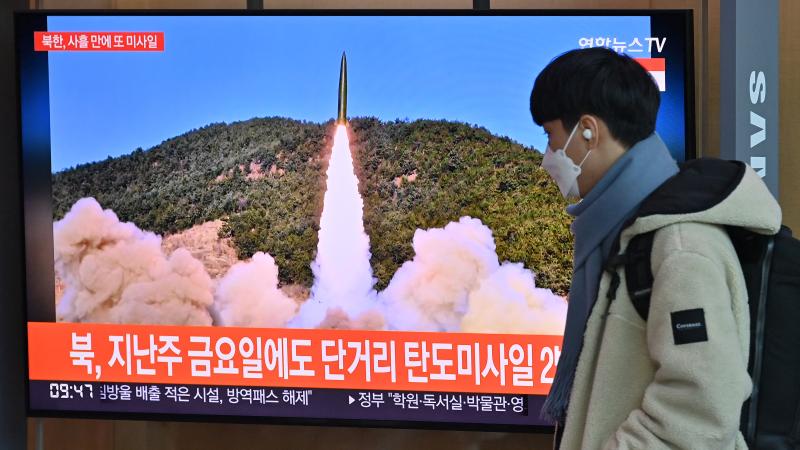 News broadcast with file footage of a North Korean missile test