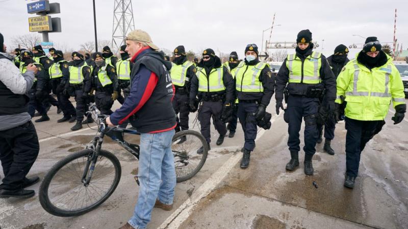 Police clear protesters on the Ambassador Bridge, Feb. 12