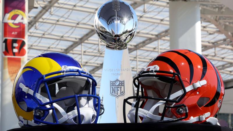 Helmets of the Los Angeles Rams and Cincinnati Bengals sit in front of the Lombardi Trophy
