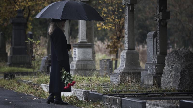 A mourner at a gravestone