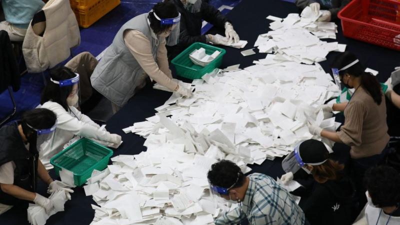 South Korean election officials sort voting papers for ballot counting in the presidential election
