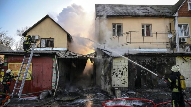 Firefighters extinguish a fire on a house after shelling on the 17th day of the Russian invasion of Ukraine