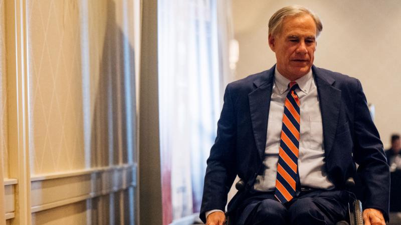 Texas Gov. Greg Abbott leaves the stage after speaking in Houston.
