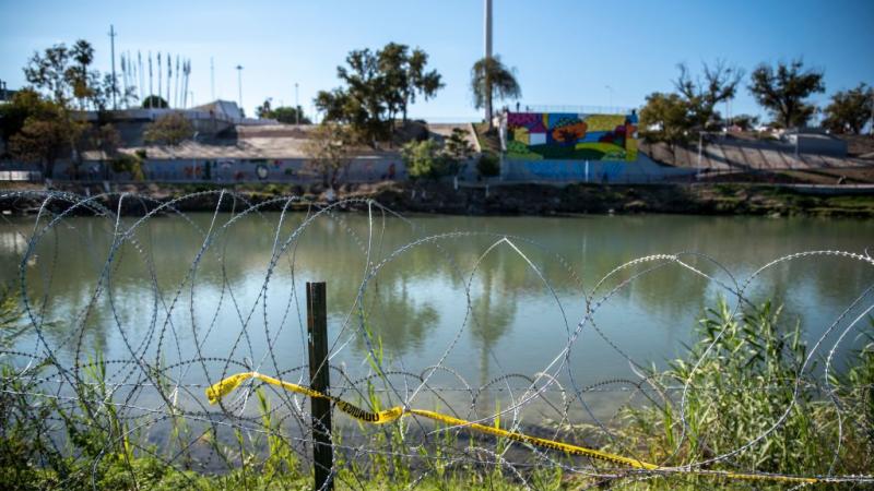 Razor wire lines the area near the Rio Grande river