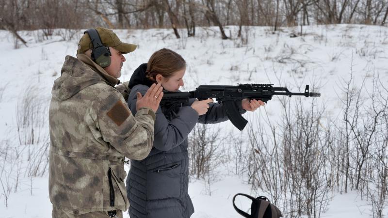 Shooting instructor, student with AK-47, Feb. 6, 2022, Ukraine
