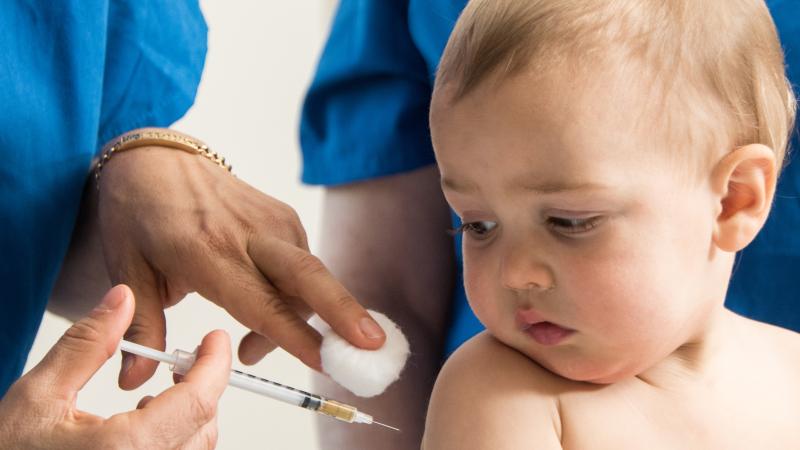 Baby boy being vaccinated, stock image