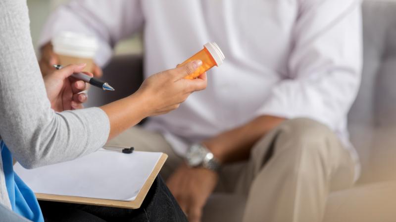A health official dispensing a prescription. 