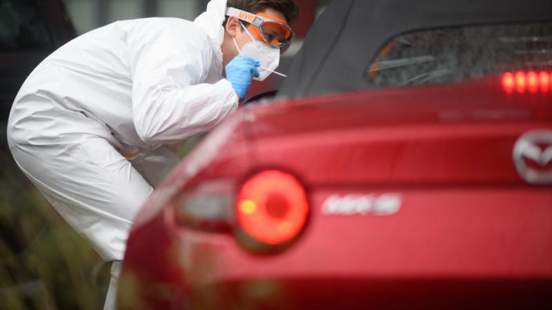 A German doctor tests a patient for infection, March 2022