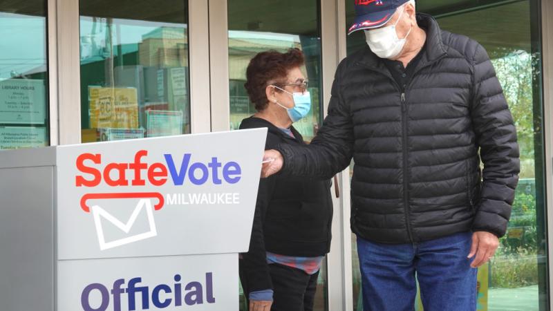 Voters drop off ballots in a Milwaukee drop box, Oct. 2020