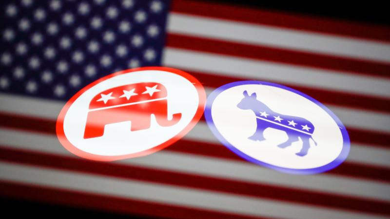 Republican and Democratic parties logos displayed on a phone screen and American flag displayed on a laptop screen are seen in this multiple exposure illustration photo taken in Krakow, Poland on August 25, 2022.