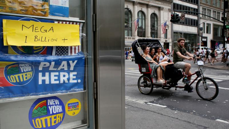 A sign advertising the billion-plus Mega Millions jackpot
