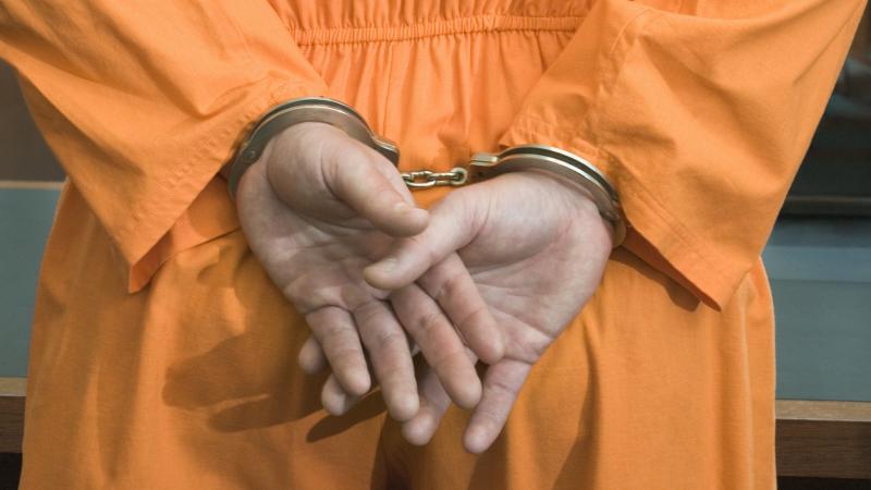 Prisoner in handcuffs, stock photo