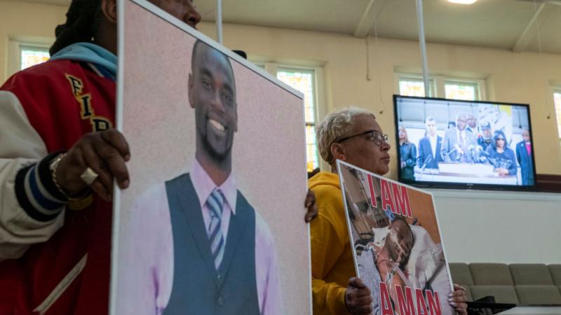 Activists hold photos of Tyre Nichols, Jan. 23