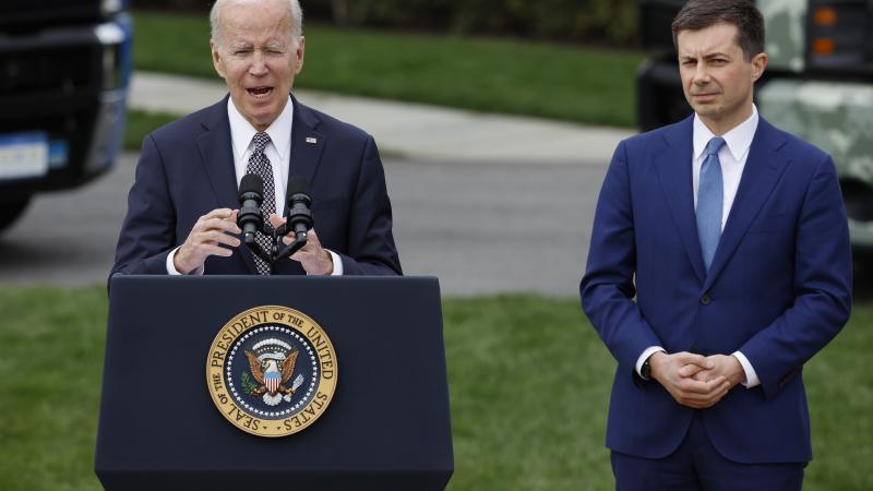 Buttigieg stands next to Biden