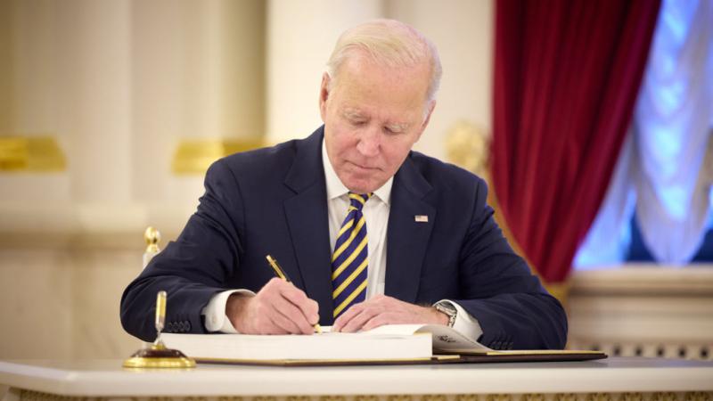 Biden signing a document
