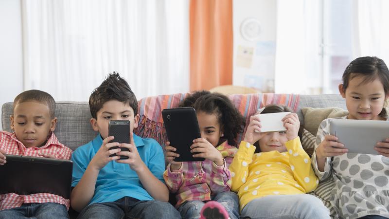 Child phone addiction, stock photo
