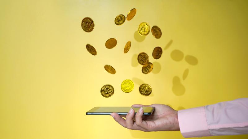 Gold coins, phone, digital currency, stock photo