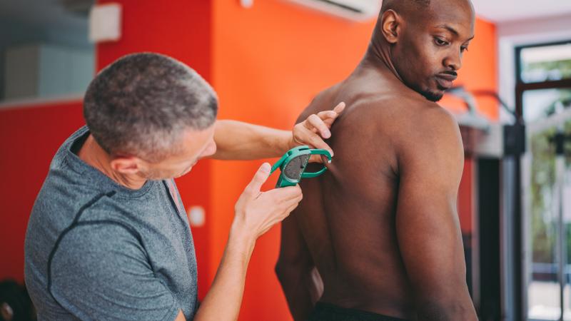 Man measures body fat percentage