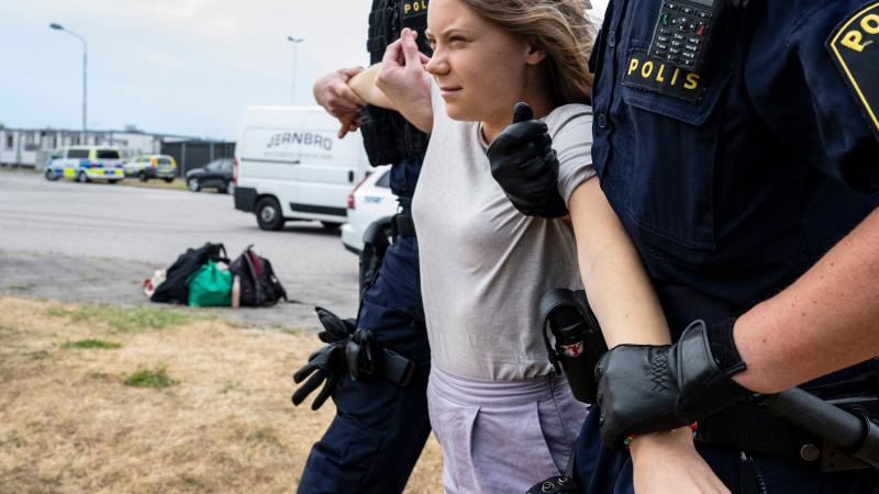 Greta Thunberg being carried away by Swedish police