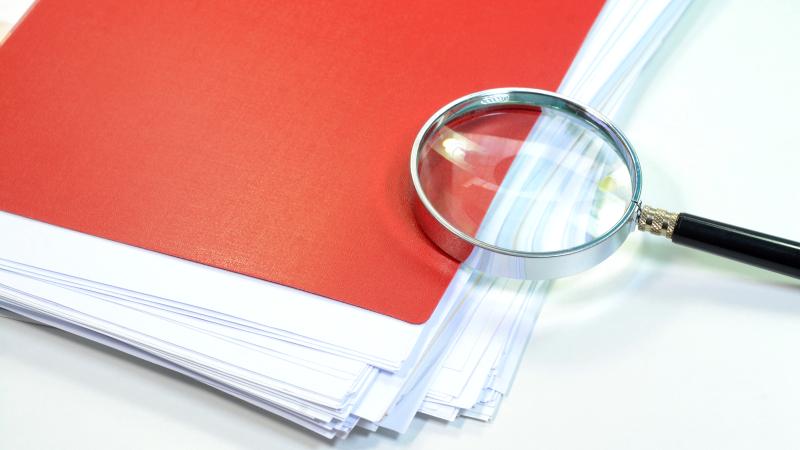 Paper and magnifying glass