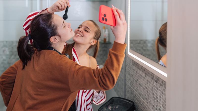 Girls bathroom, phone, file photo