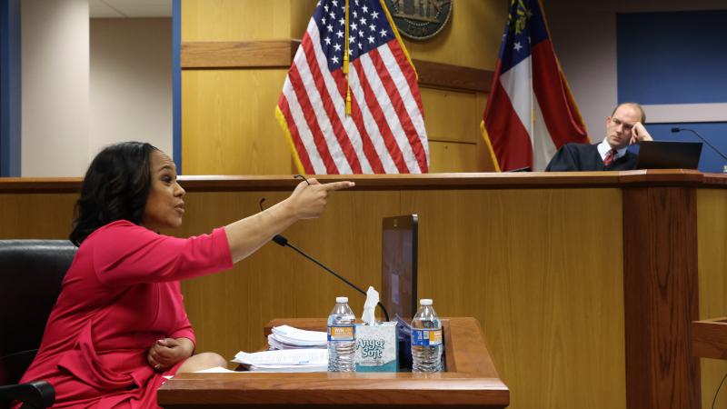 Attorney Fani Willis speaks from a witness stand in front of Fulton County Superior Judge Scott McAfee during a hearing in the case of State of Georgia v. Donald John Trump at the Fulton County Courthouse on February 15, 2024 in Atlanta, Georgia.